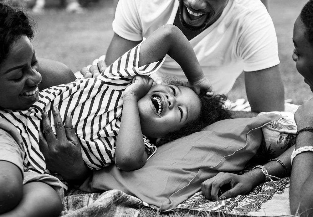 Black family enjoying summer together at backyard grayscale