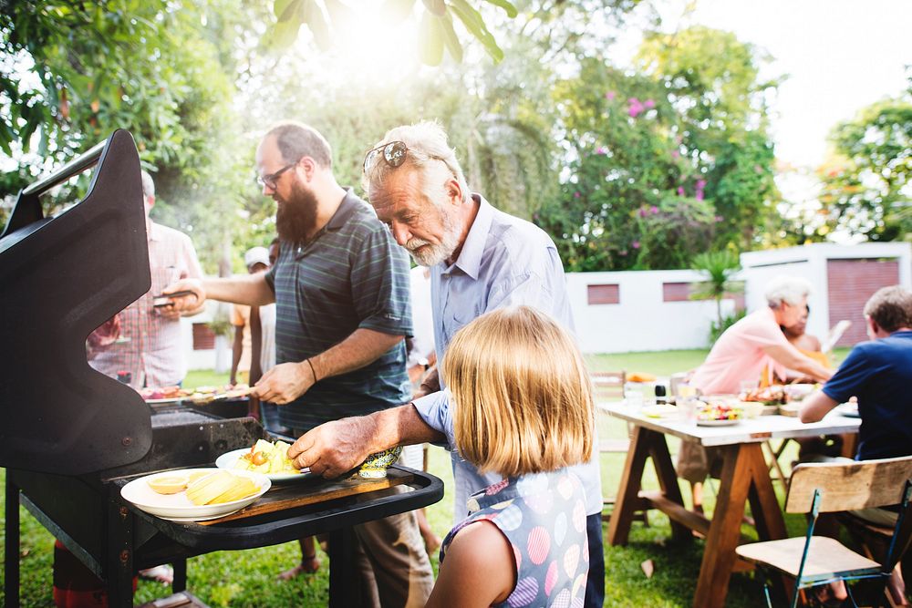 Family spending time together with barbecue party in the yard