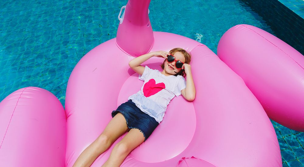Caucasian girl relaxing in a pool