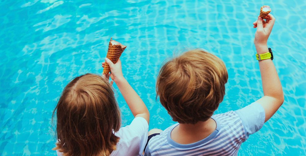 Kids having ice cream by the pool