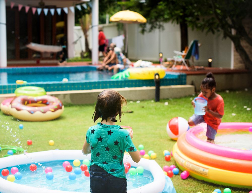 Children enjoy rubber pool outdoors