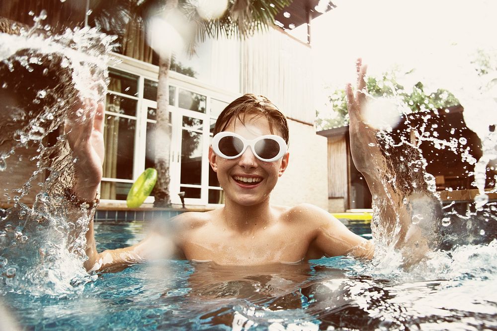Teenage boy having fun in swimming pool