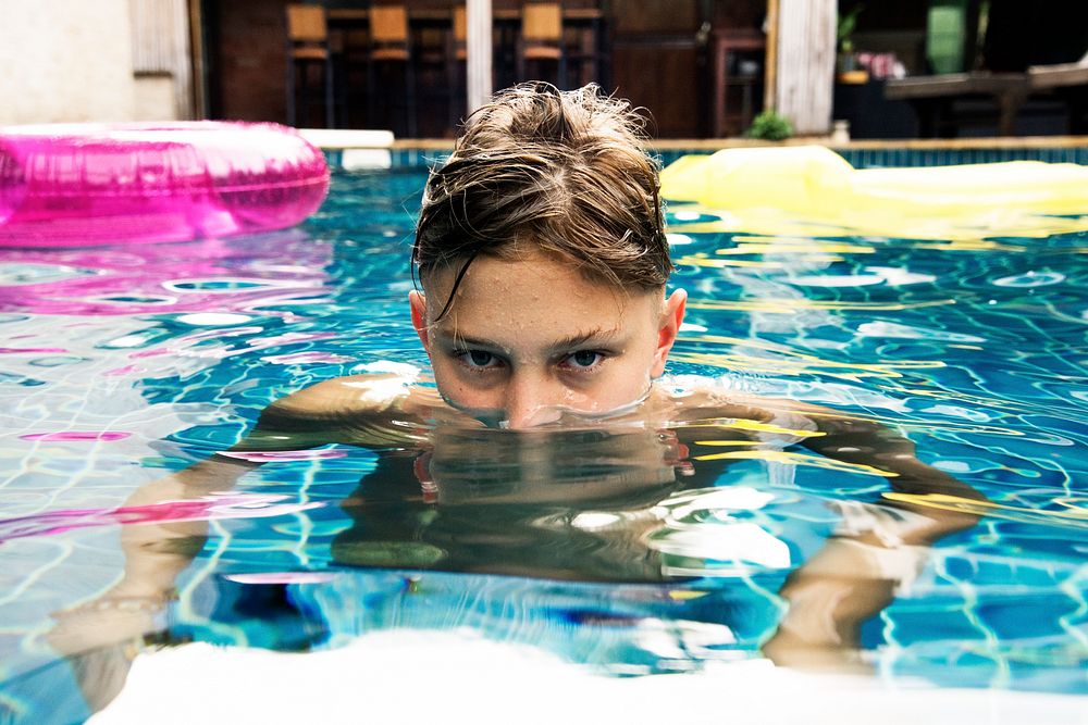 Teenage boy swimming in the pool