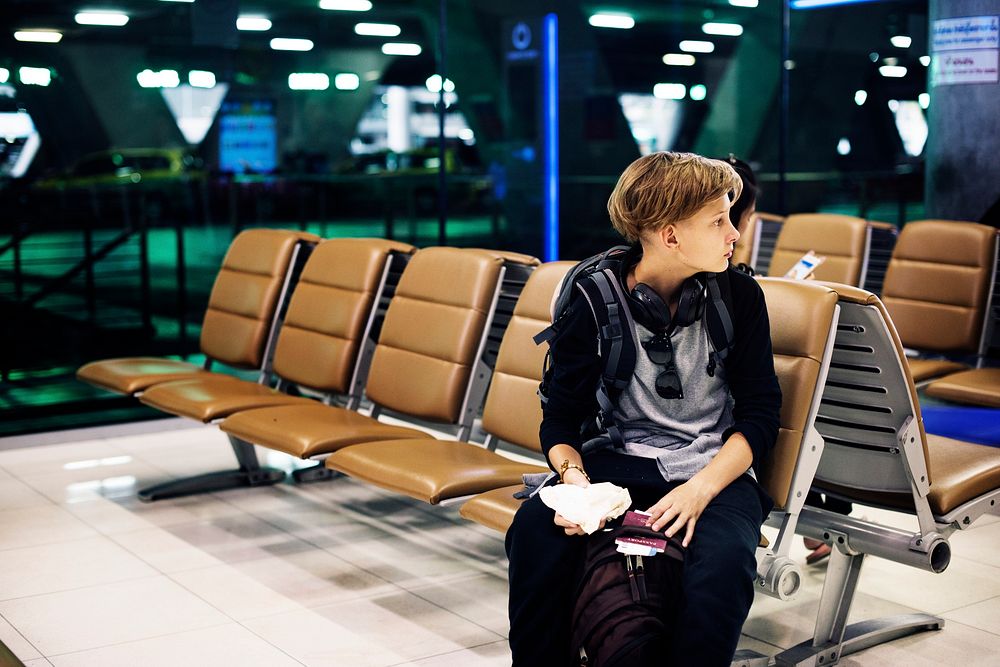 Young caucasian man sitting waiting at airport