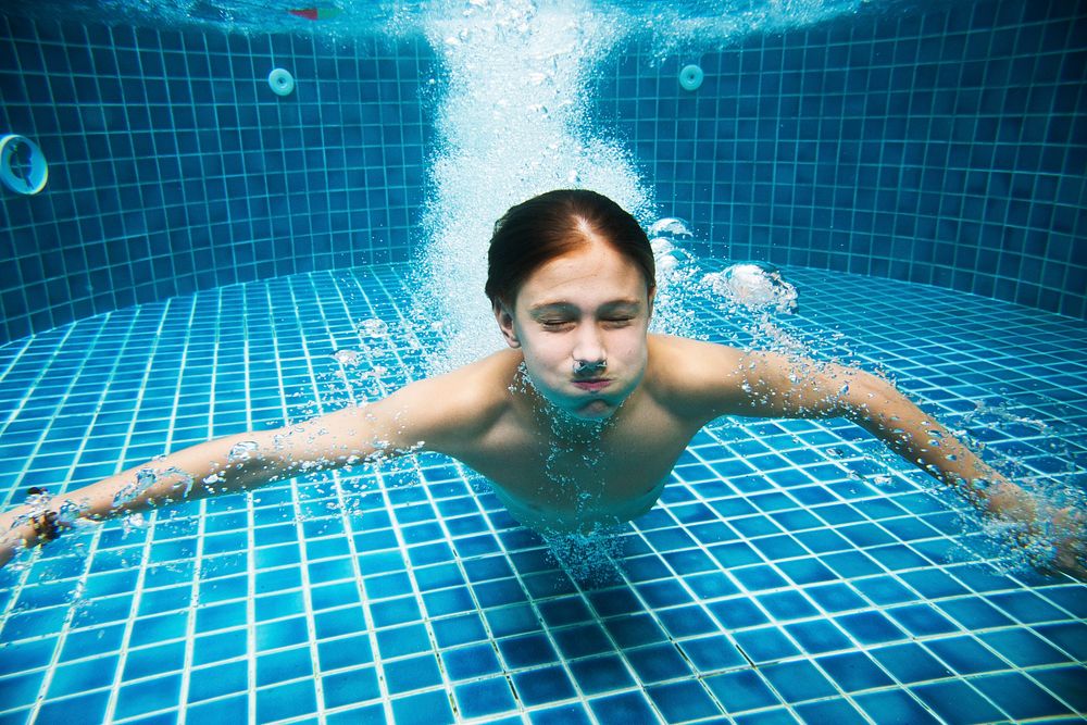 Young caucasian boy enjoying the pool underwater