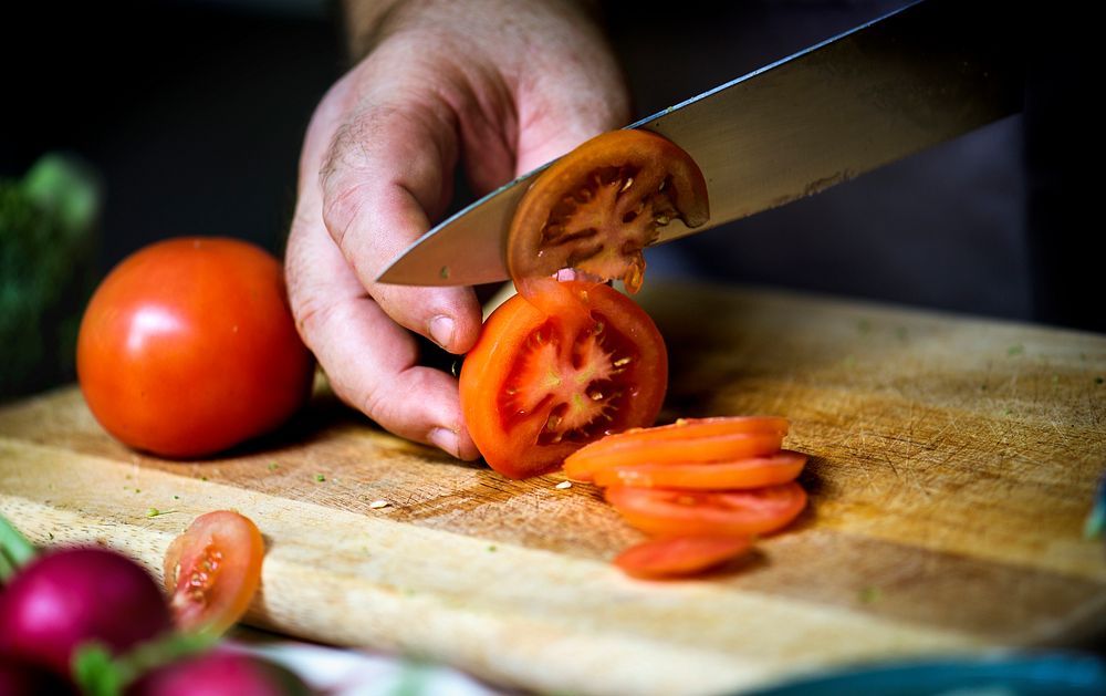 A person slicing tomato