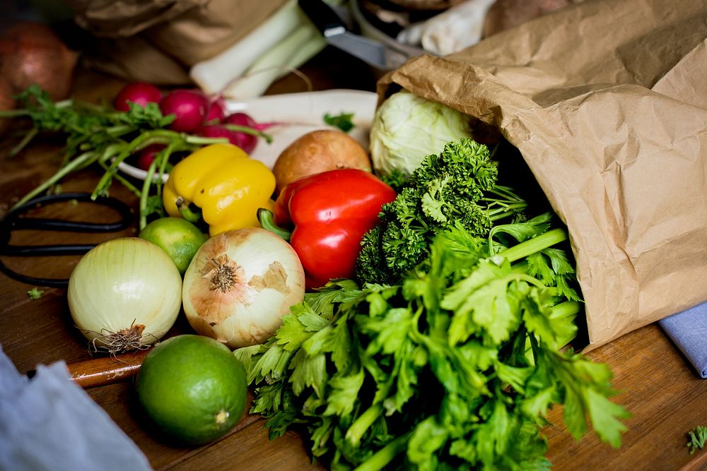 Fresh vegetable in a paper bag on the table