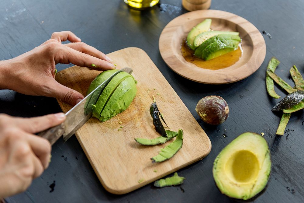 Closeup of fresh avocado on wooden cut board