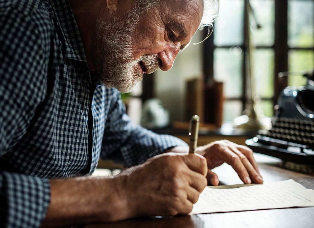 Elderly man writing a letter
