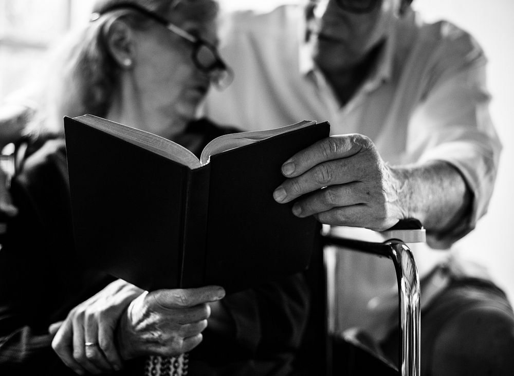 Senior woman on a wheelchair reading a book