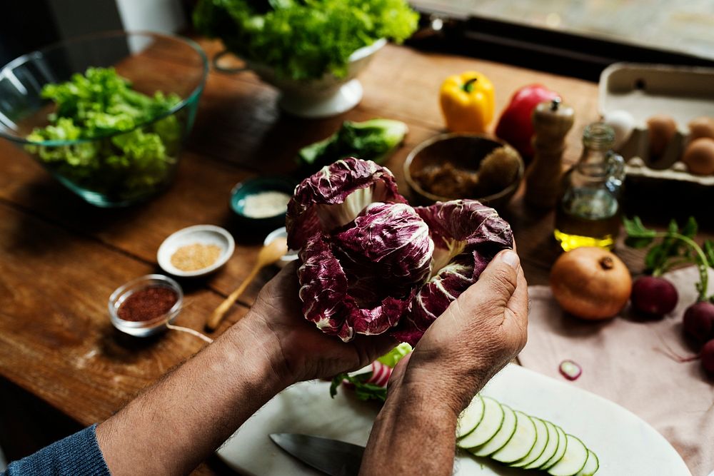 Hands holding cabbage in a kitchen
