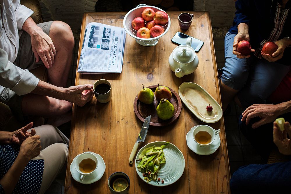 Seniors having a tea break with fruits