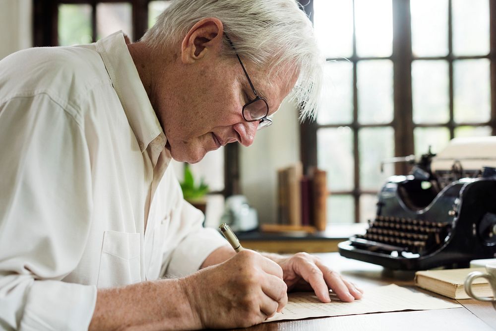 Elderly man writing a letter
