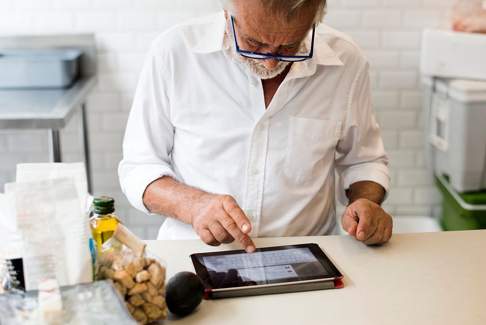 Senior caucasian man using digital tablet