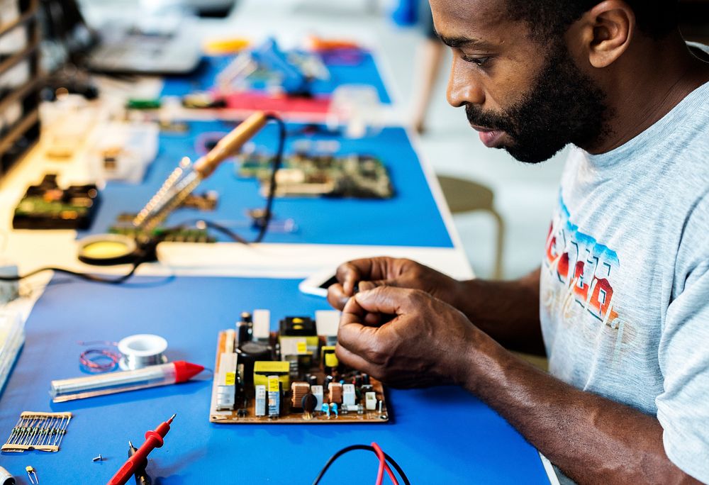 African ethnicity technician man working at his station