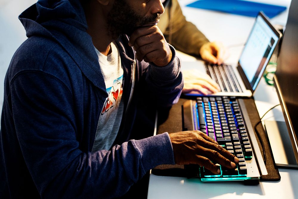 African descent man hands working on computer keyboard