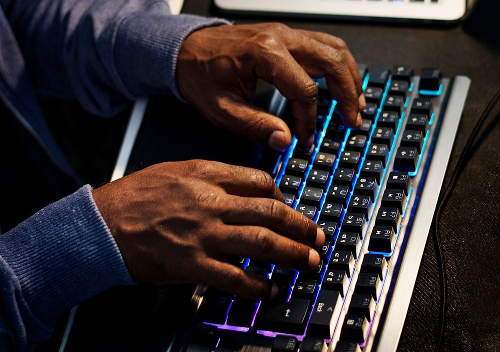 Closeup of hands working on computer keyboard