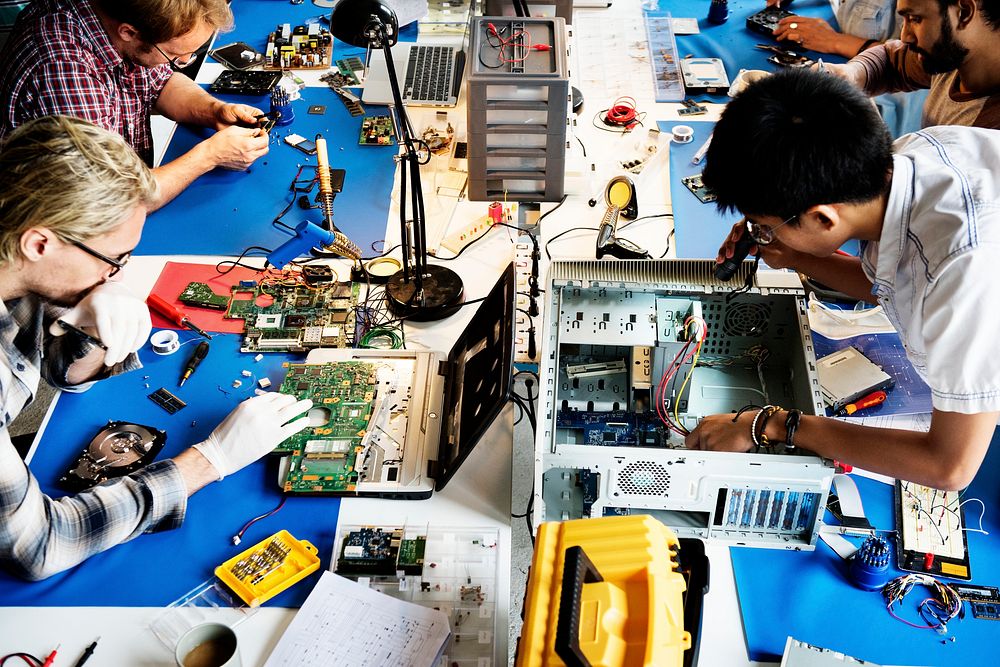 Electronics technicians team working on computer parts