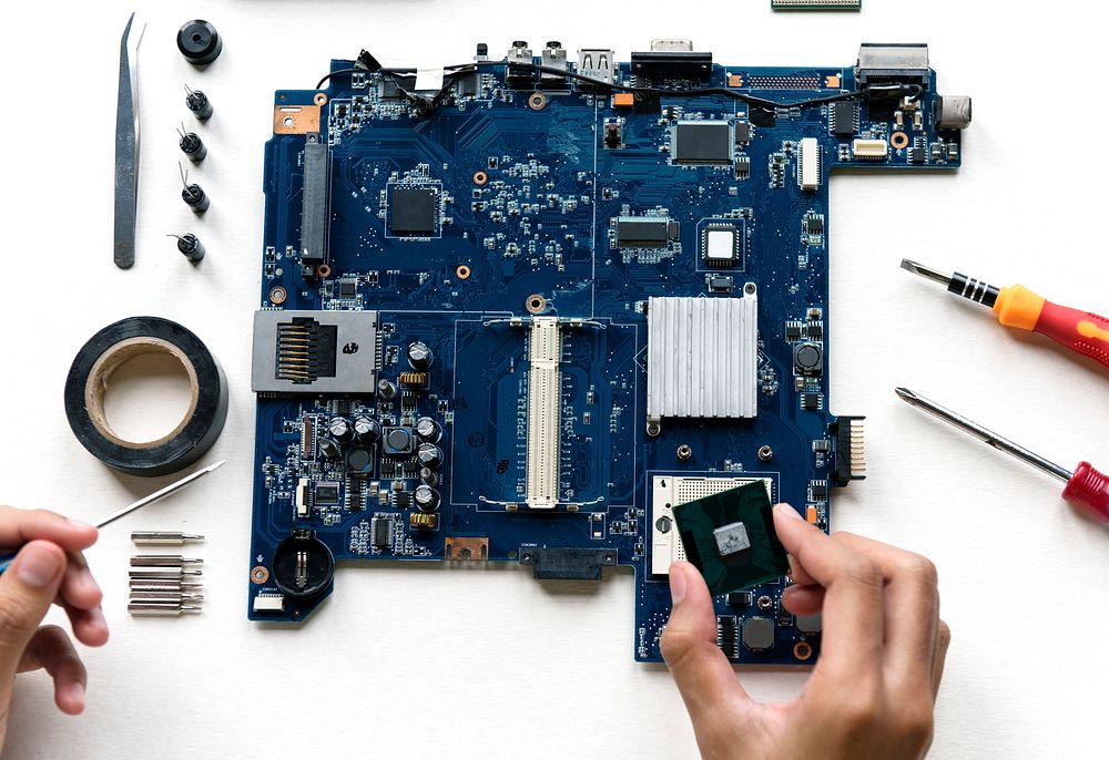 Aerial view of hands with computer components on white background