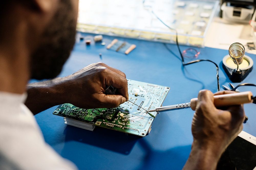 Closeup of tin soldering with electronics circuit board