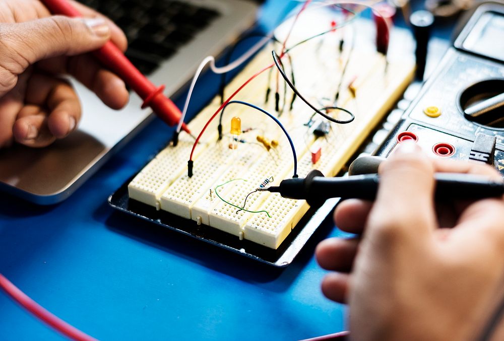 Closeup of multimeter measuring breadboard