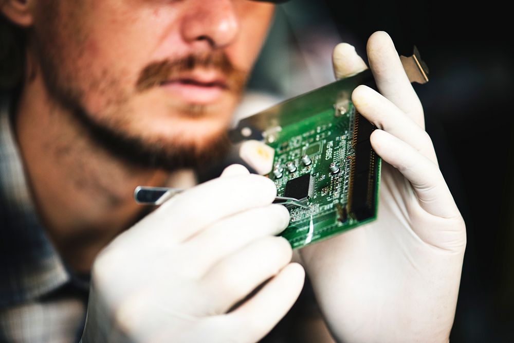 Closeup of hands working on computer motherboard