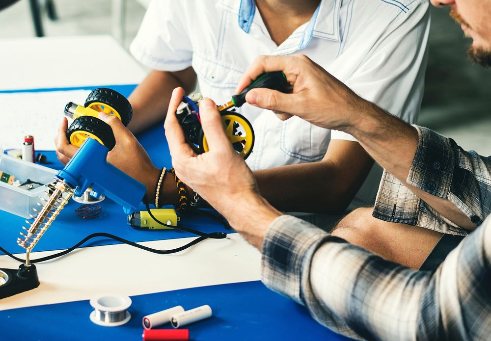 Group of people working at eletronic repair shop