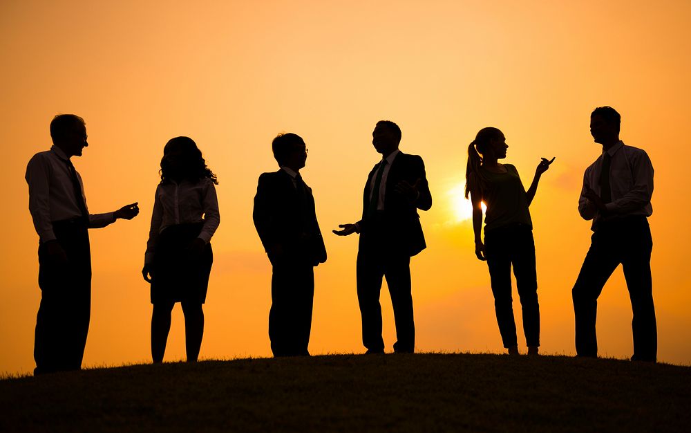 Silhouette of business people standing in a row communicating