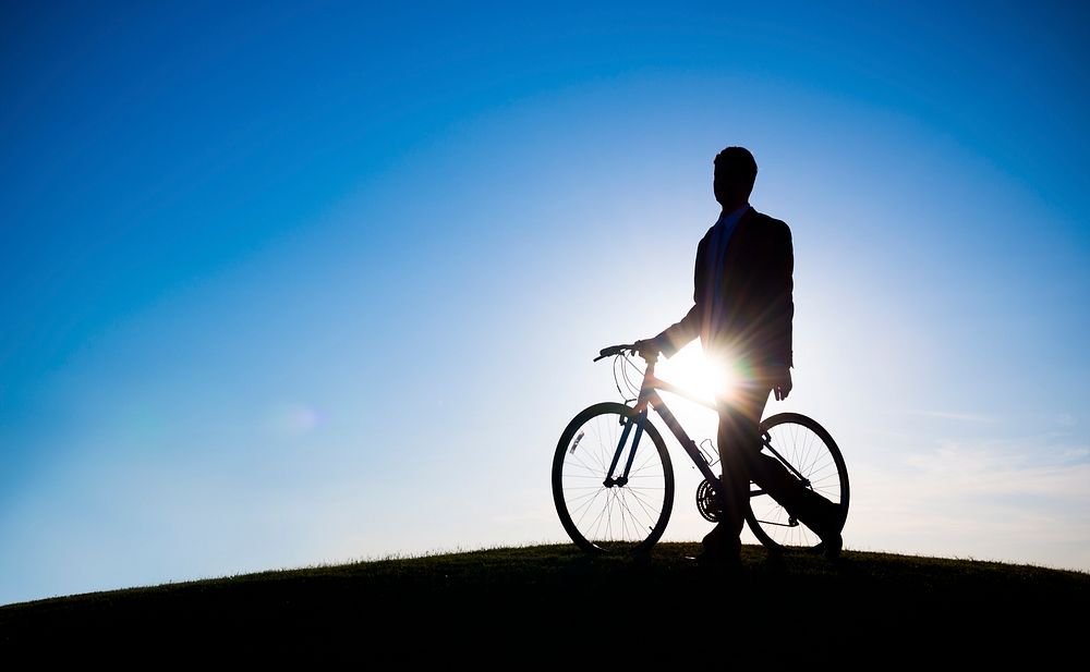 businessman holding bicycle,
