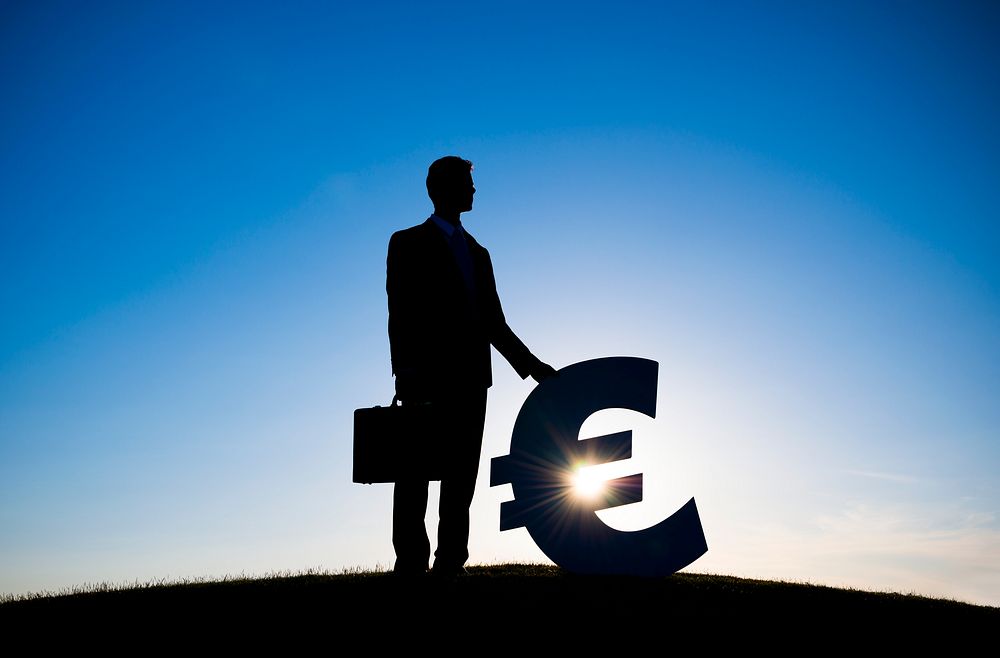 Businessman holding EURO currency sign
