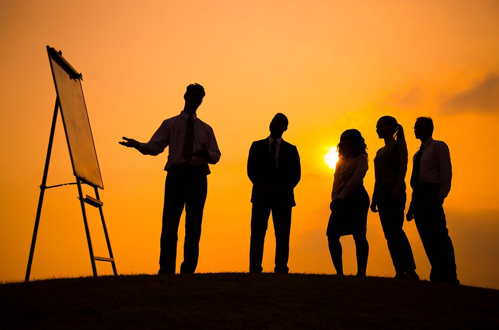 Silhouette of business people doing a presentation