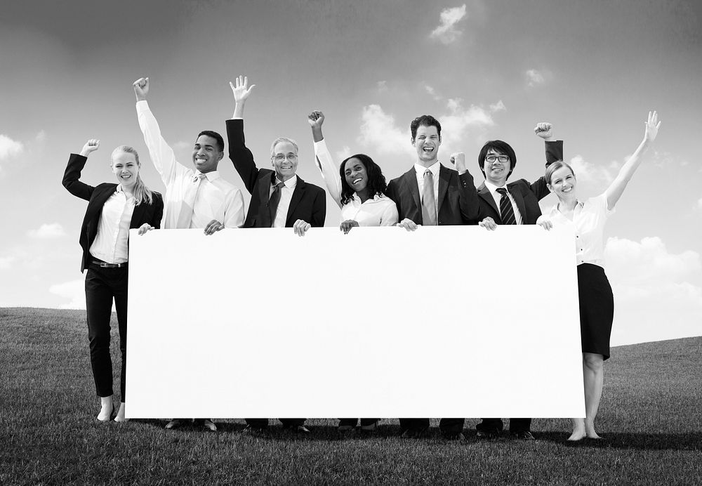 Business people holding a placard