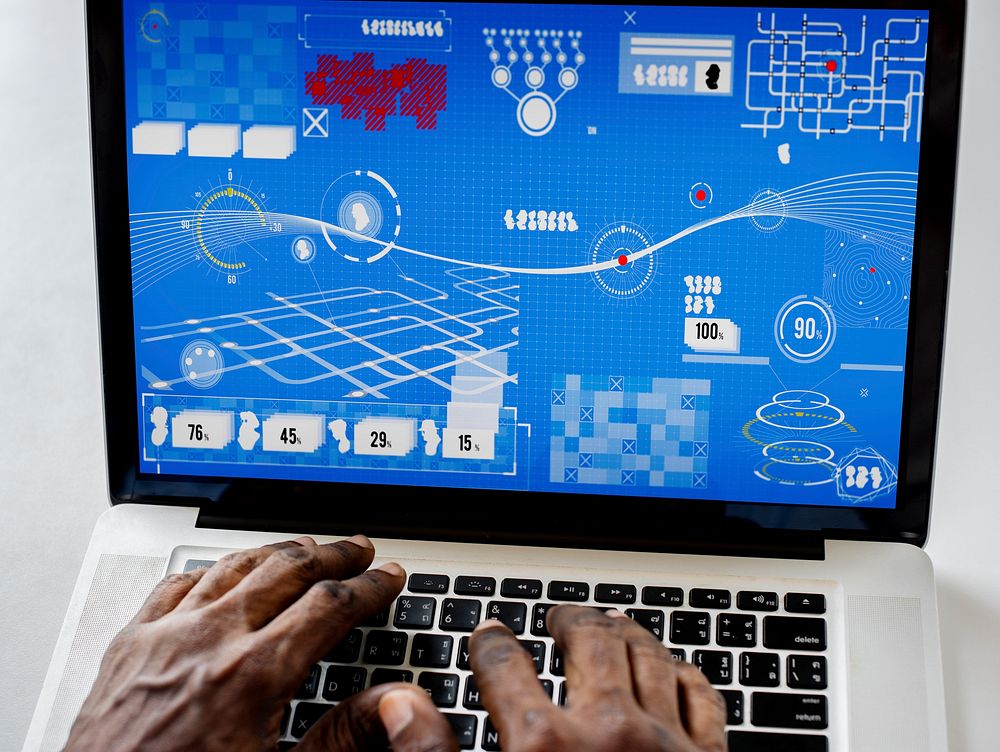 Hands on a laptop with infographic on screen