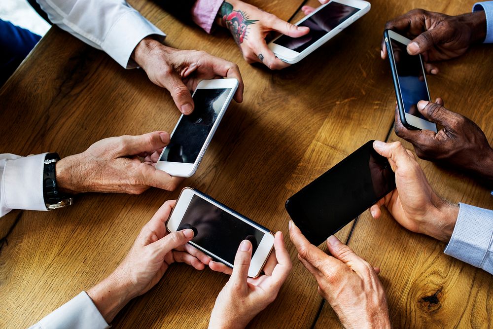 People hands using smartphone in a meeting