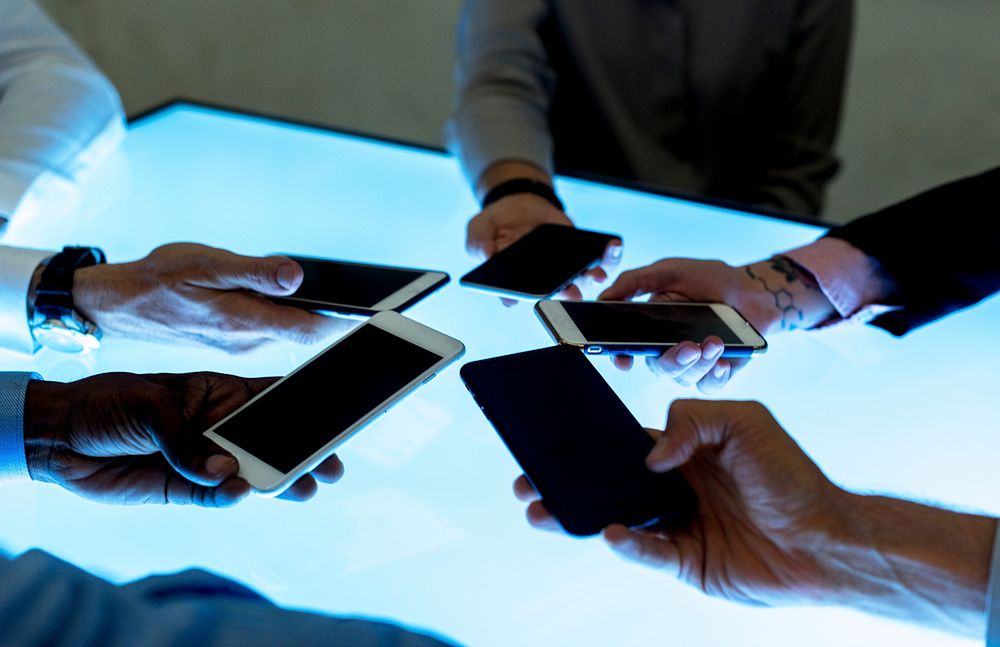 People in a meeting using smartphone