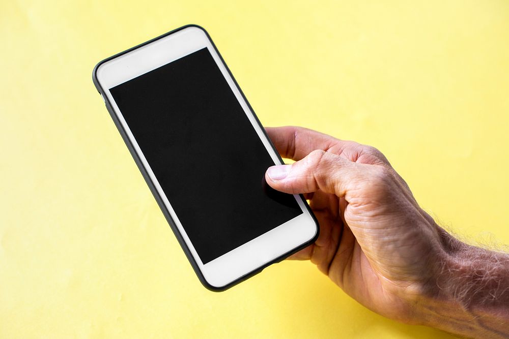 Hand holding smartphone isolated on background