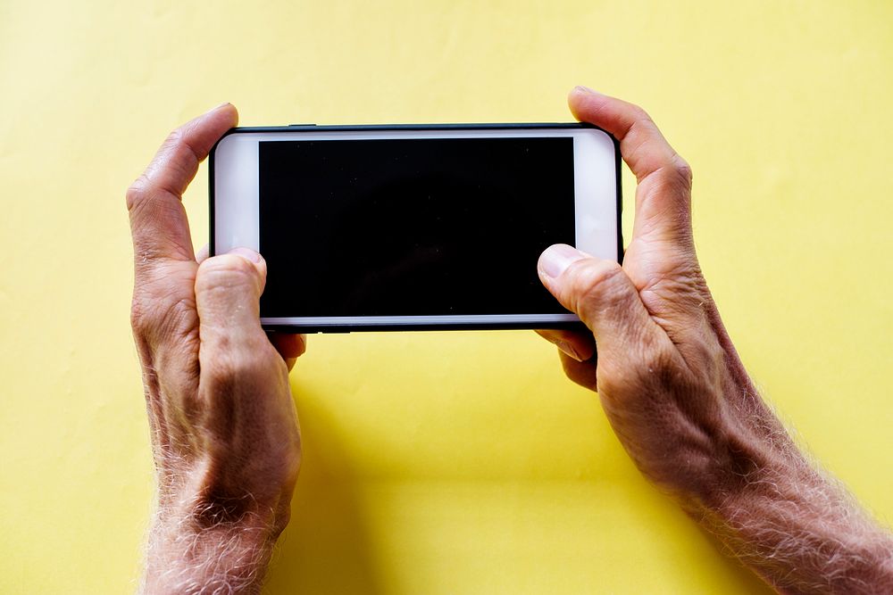 Hands holding smartphone isolated on a background