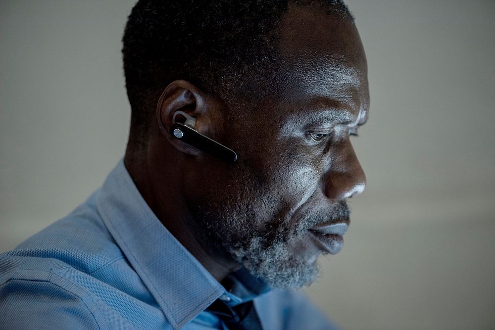 African ethnicity businessman with bluetooth earphone