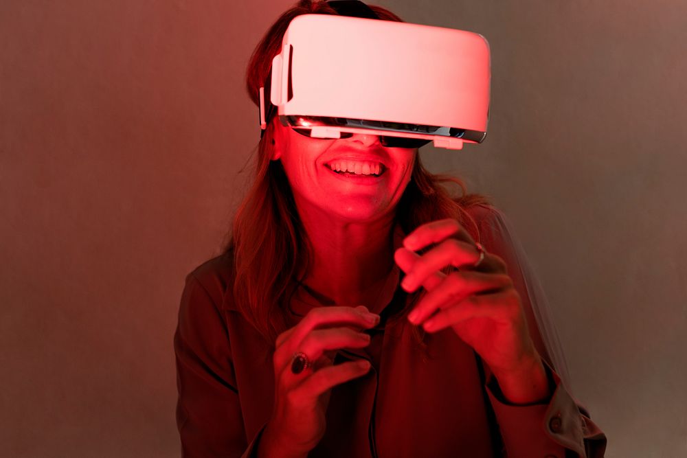 Woman using virtual reality gadget for entertainment