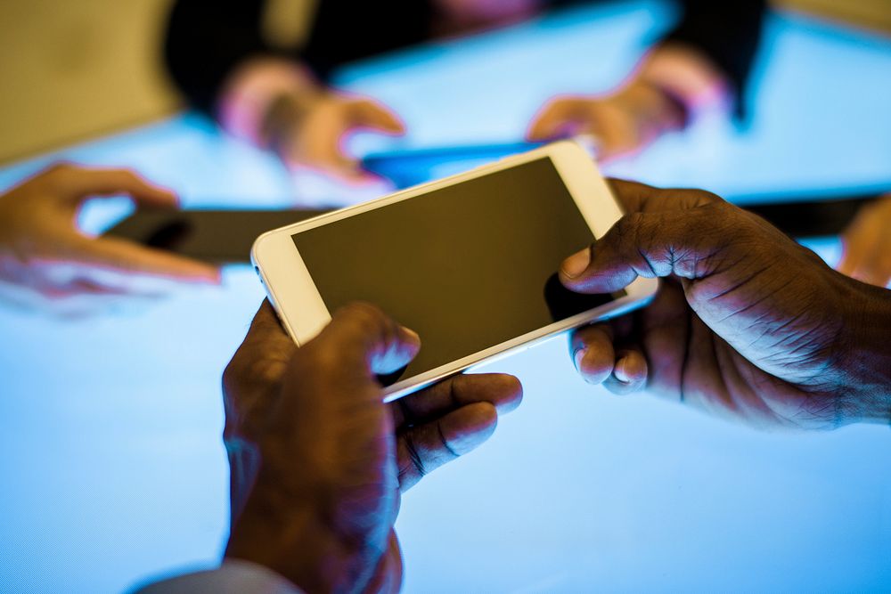 Group of hands holding using smartphone