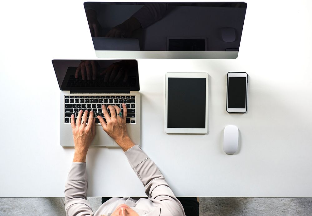 People working at the table with digital device