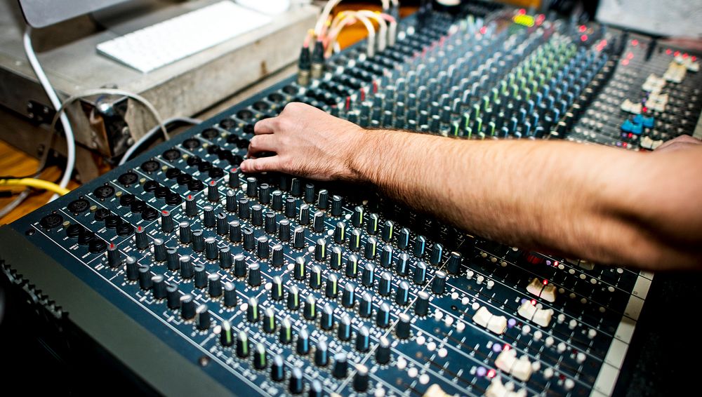 Hand on a sound mixer station