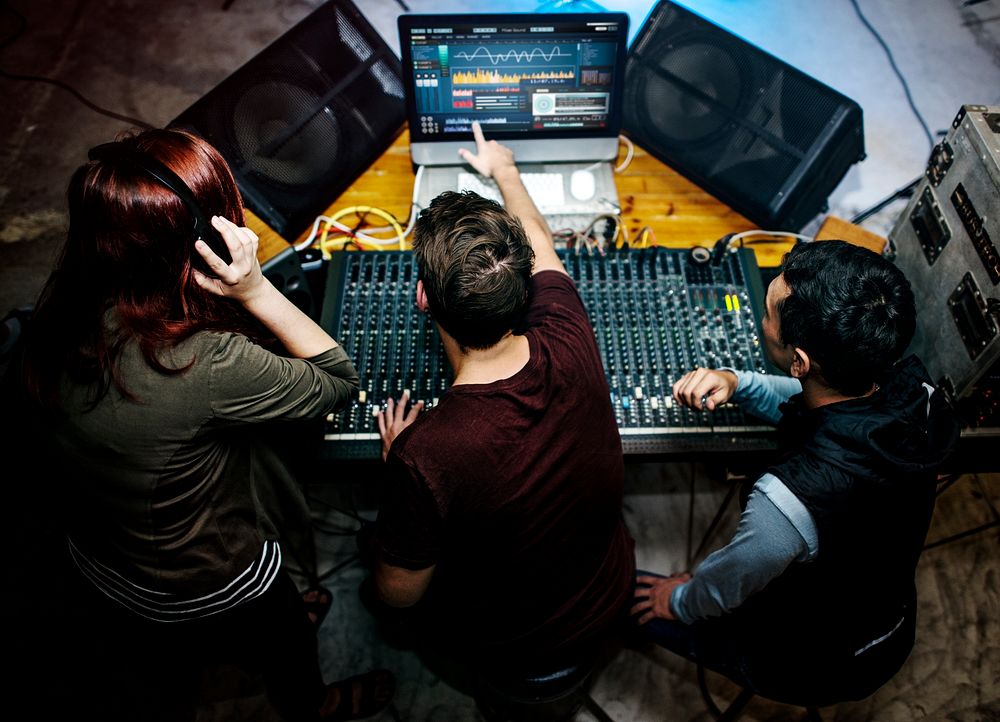Group of people at a sound mixer station