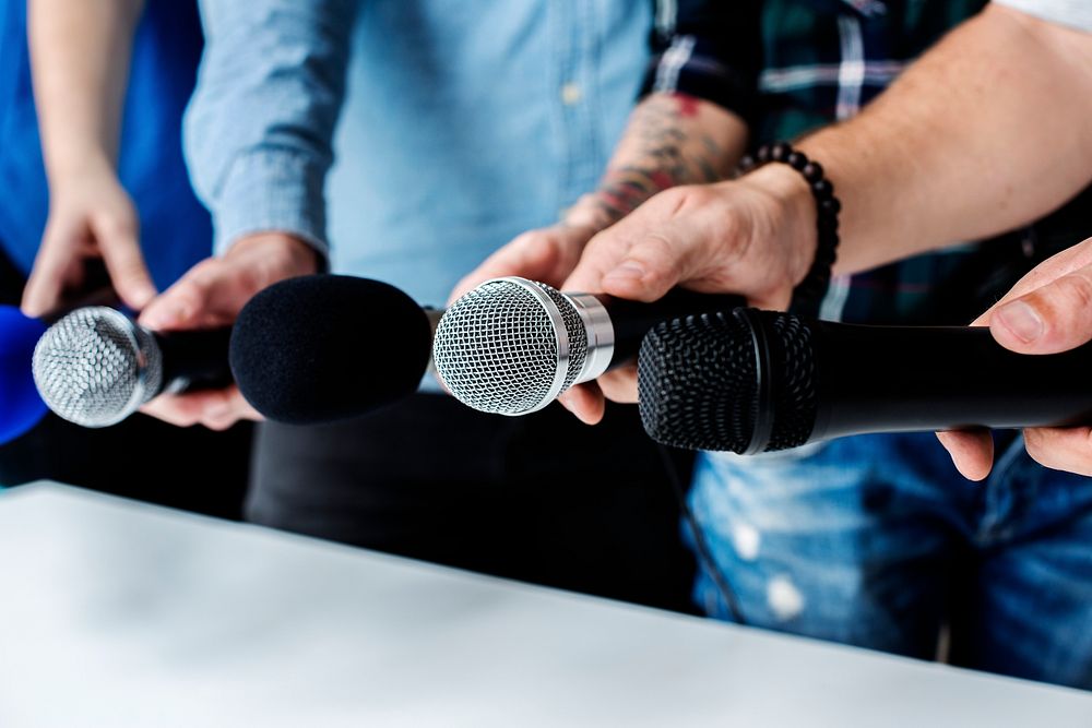 Hands holding microphone for an interview