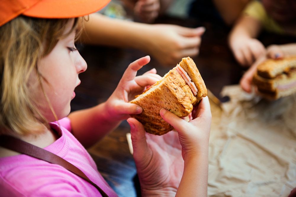 Closeup of young caucasian girl with homemade sandwich