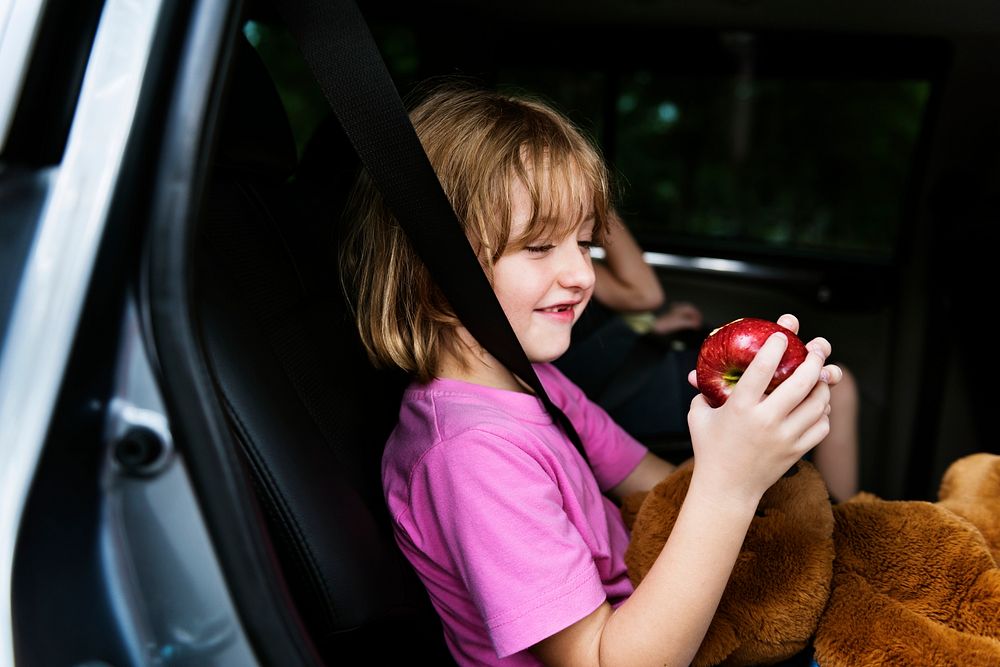 Young girl sitting inside a car