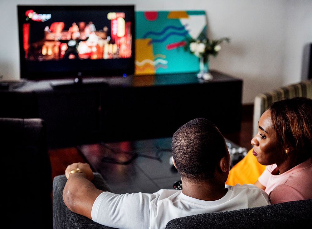 Black spouse watching movie enjoy precious time together