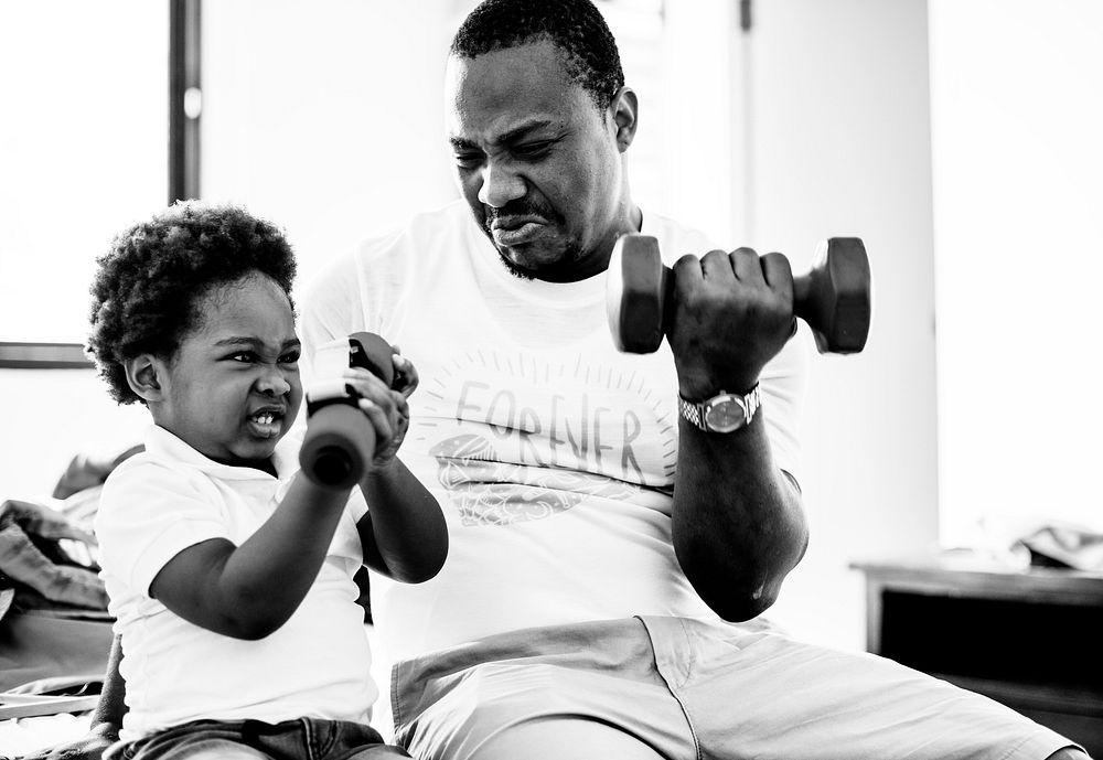 Grayscale of black family exercising