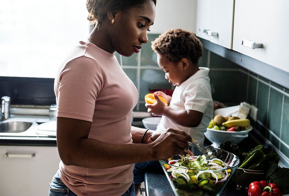 Black kid with mom in the kitchen