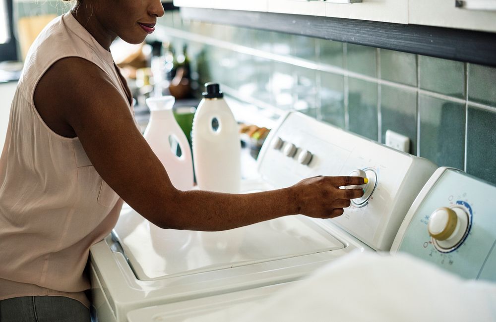 Black woman using washing machine